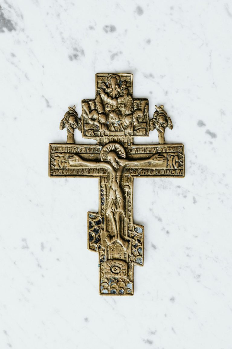 Gold Cross on White Surface